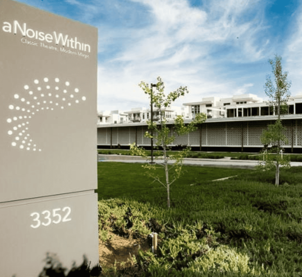 Modern architectural building with lush landscaping and eco-friendly design, promoting sustainable living.