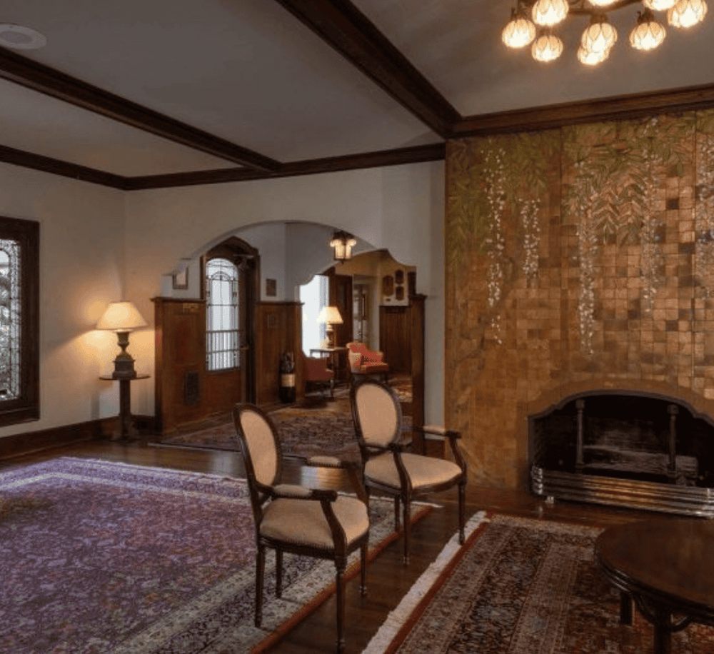 Elegant living room with classic furniture and warm lighting, showcasing timeless interior design.