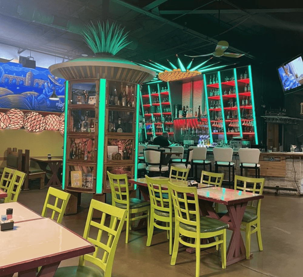 Colorful indoor bar with vibrant neon lighting and modern decor at QuestForDirections.