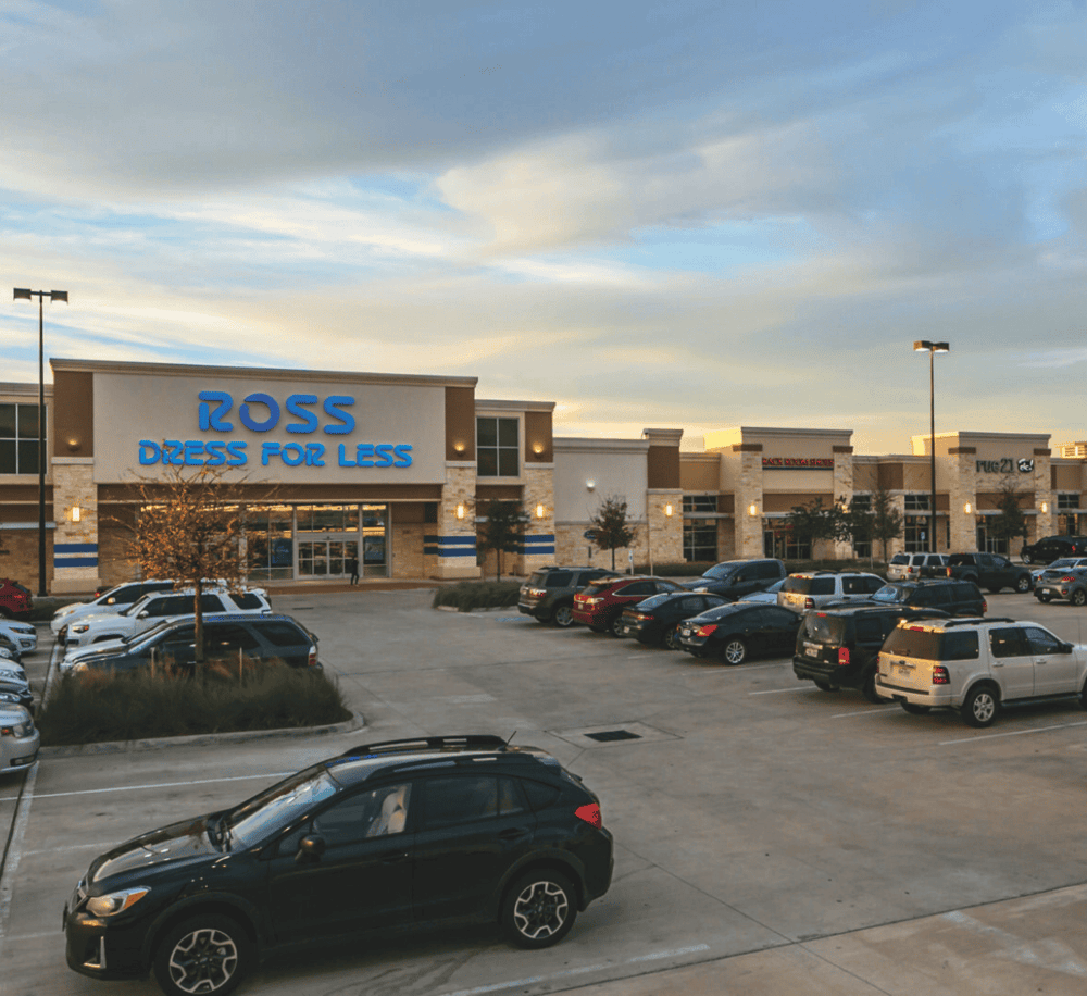 Modern retail shopping center with Ross Dress for Less store and parking lot.