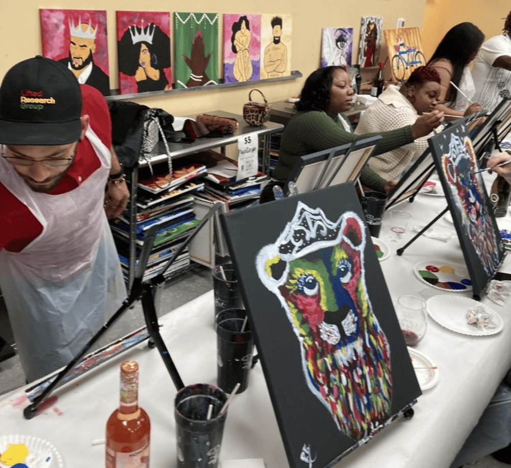 Vibrant abstract lion painting at themed painting event, guests creating colorful artwork in an artistic studio.