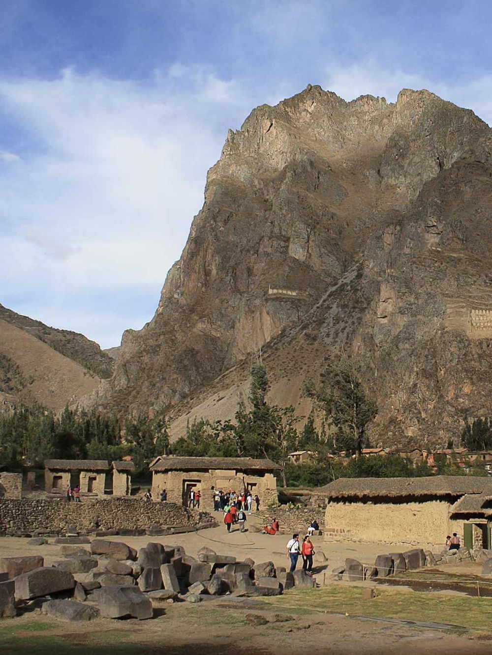 Ancient Inca ruins with mountainous backdrop, best for travel and historical tours in Peru.