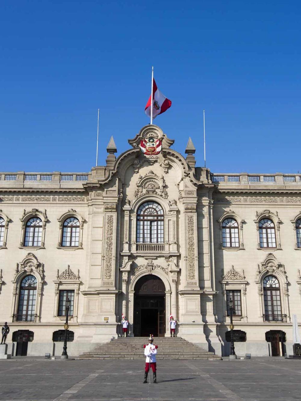 Flag of Peru on historic government building, Lima, Peru, travel destination, governmental architecture, Peruvian culture.