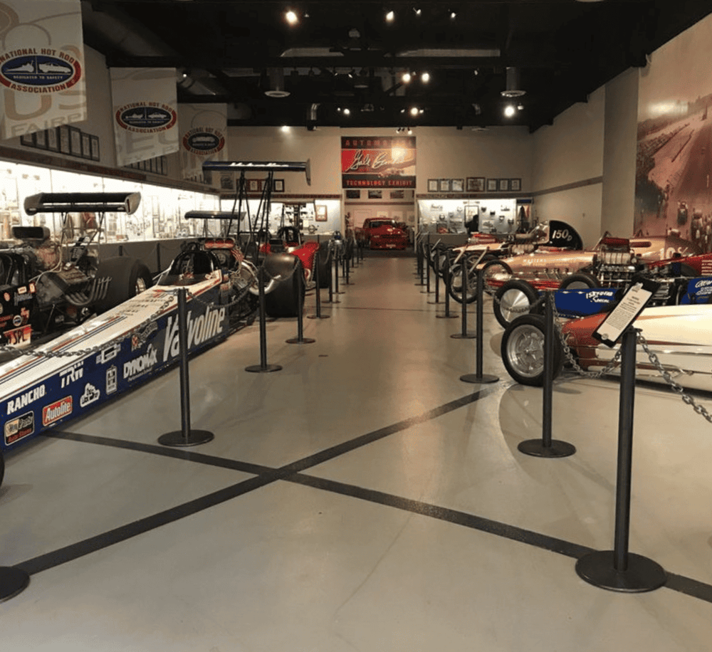 Race car museum exhibit with vintage racing cars on display at QuestForDirections.