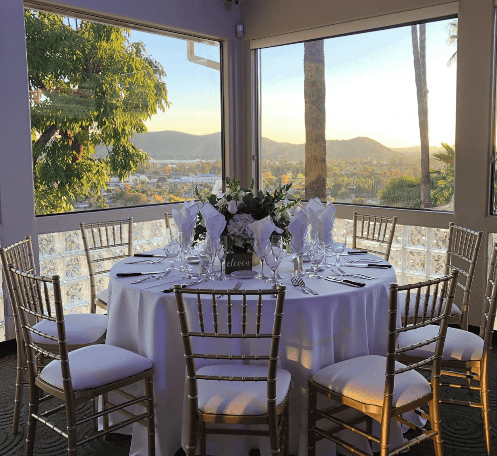Elegant outdoor dining setup with scenic mountain views at QuestForDirections event venue.