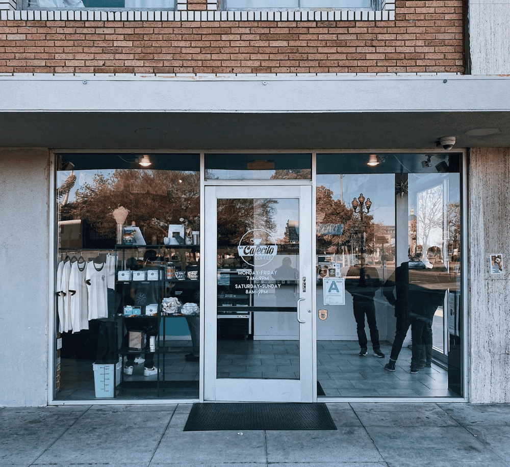 Comfortable coffee shop storefront with welcoming atmosphere and clear business hours.