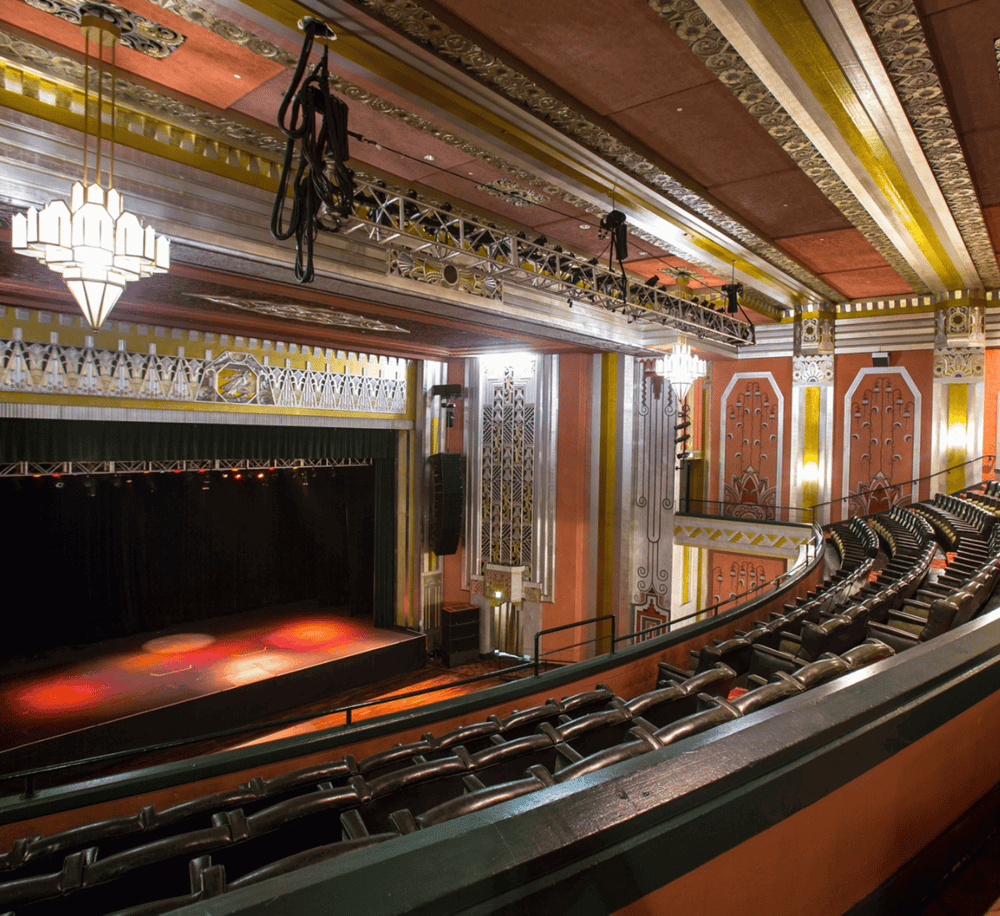 Elegant theater interior with stage, lighting, and seating, ideal for live performances and events.
