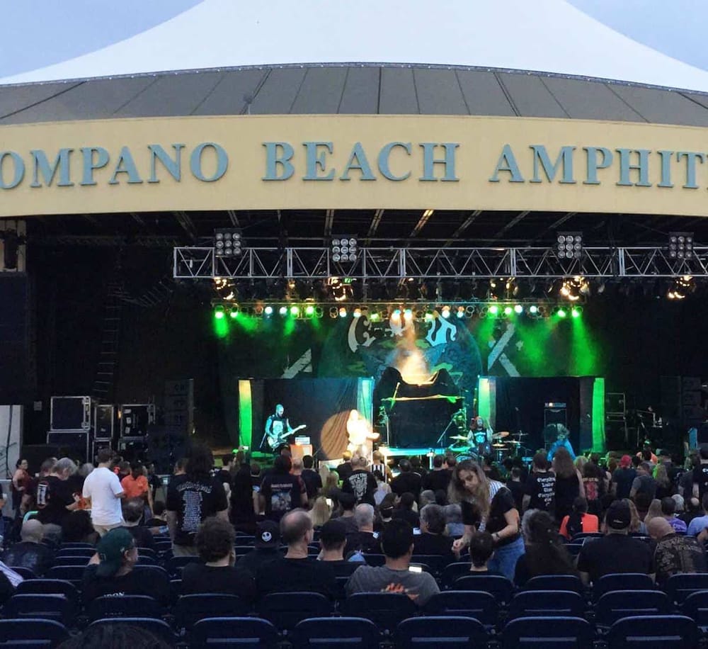 Live concert at Pompano Beach Amphitheater with audience enjoying music and vibrant stage lighting.