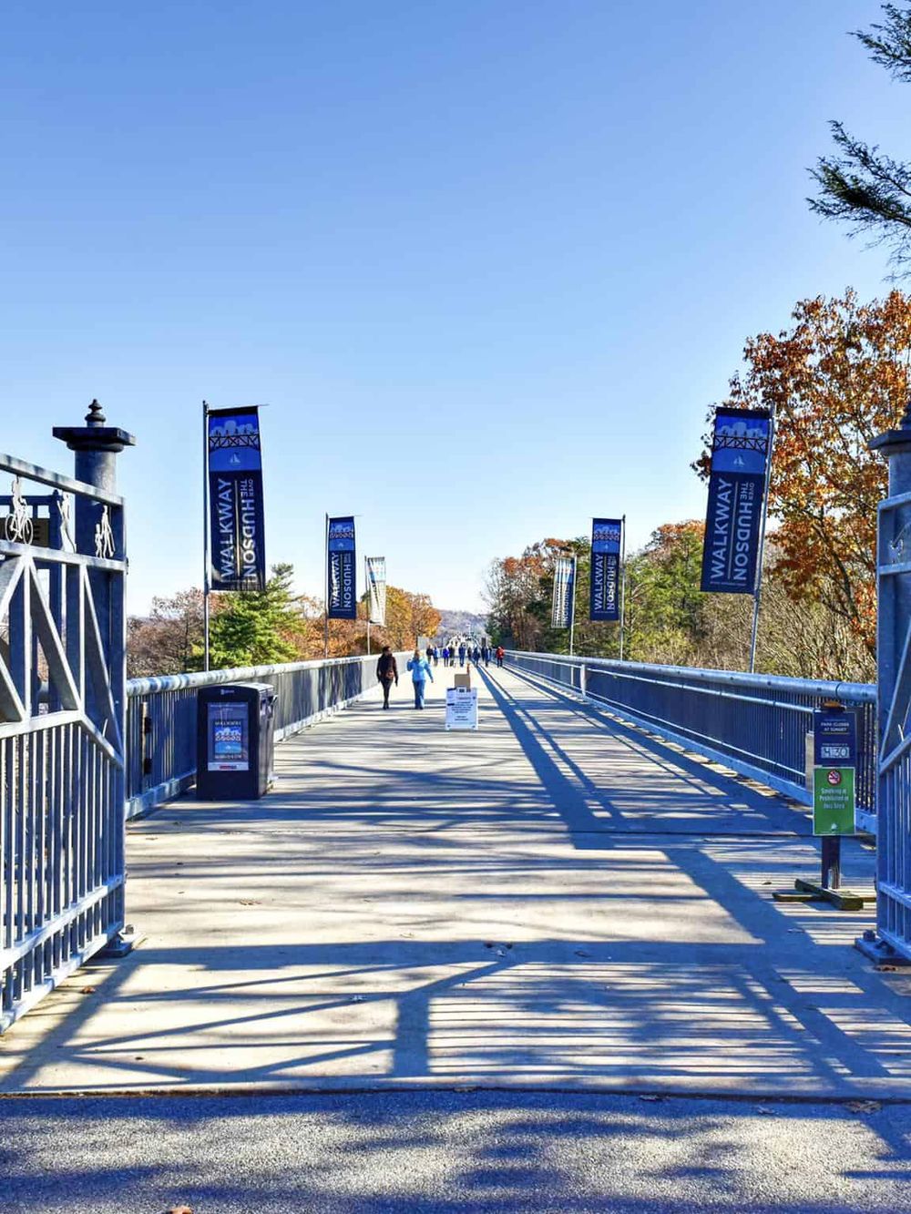 Scenic pedestrian bridge with blue banners, perfect for walkways and outdoor excursions.