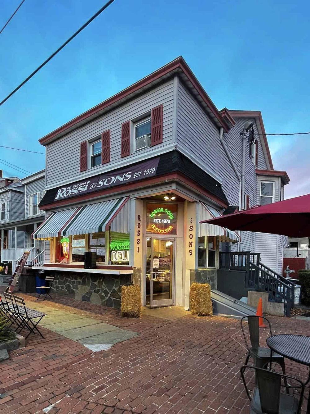Charming neighborhood deli and pizzeria with outdoor seating, inviting atmosphere, and established since 1979.