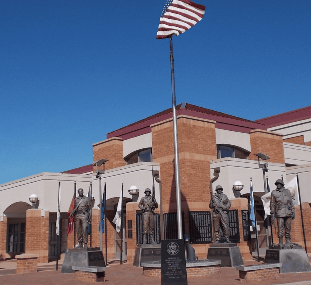 American flag and war statues at Quest for Directions monument site.