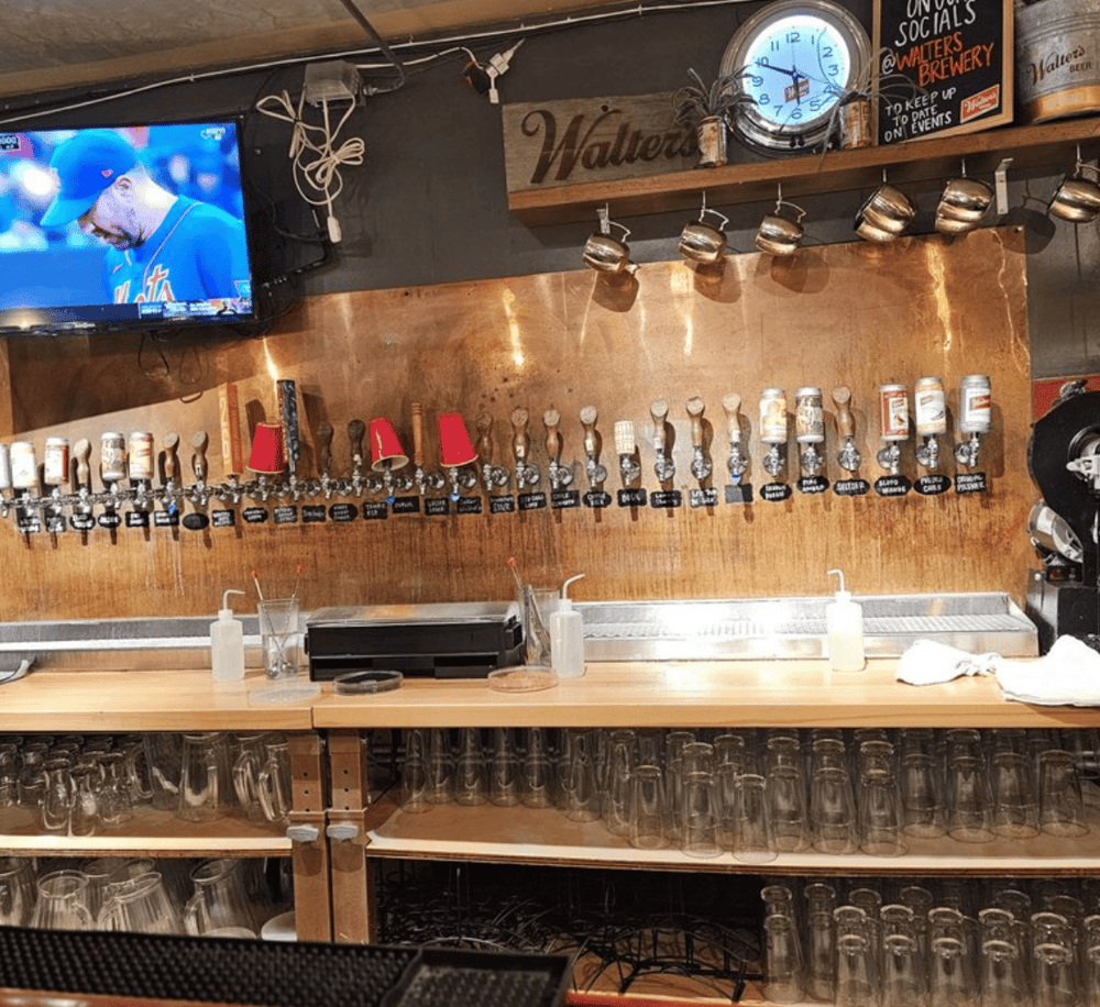 1. Wall-mounted beer taps and glassware at QuestForDirections bar, craft beer and drink menu.
