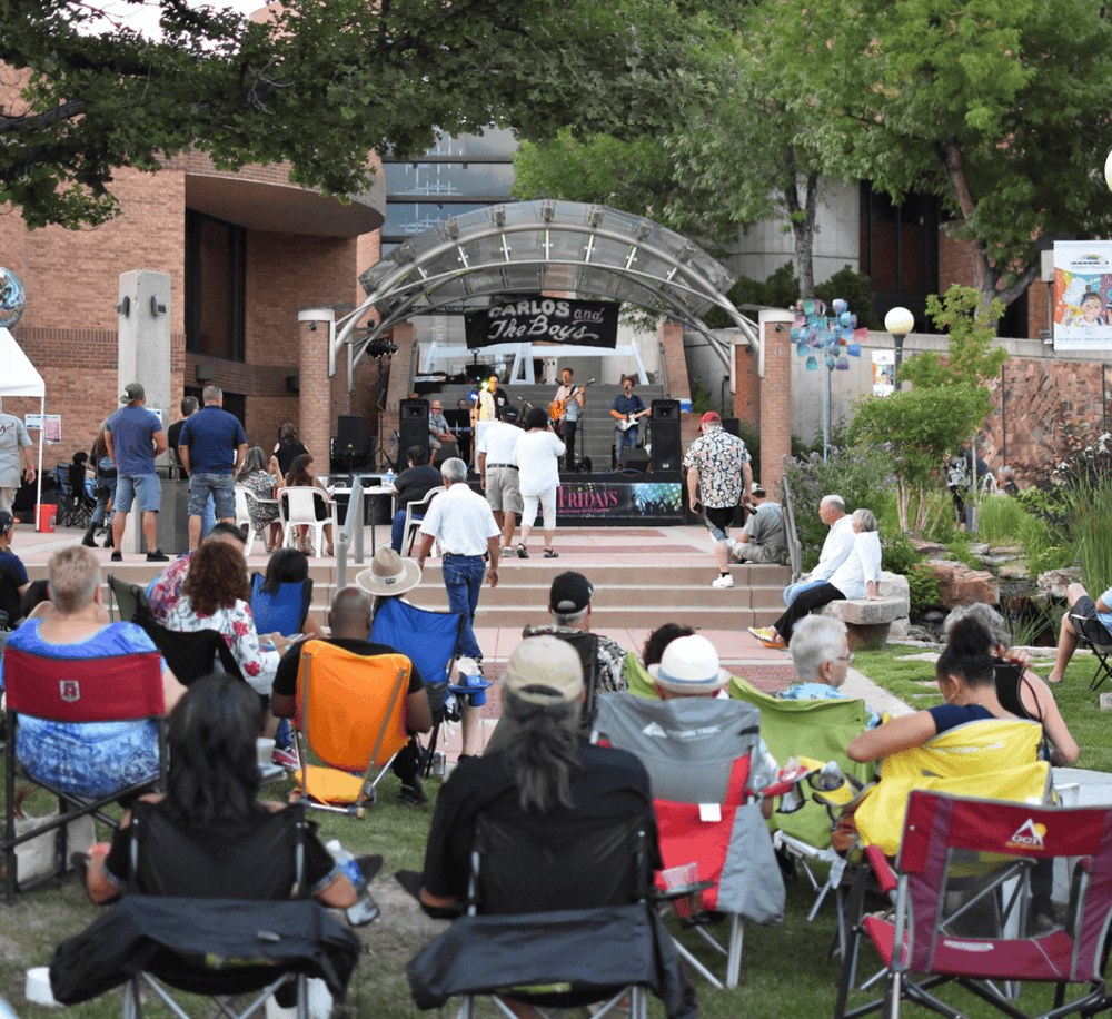 Live outdoor concert at QuestForDirections venue with audience enjoying music and relaxing.