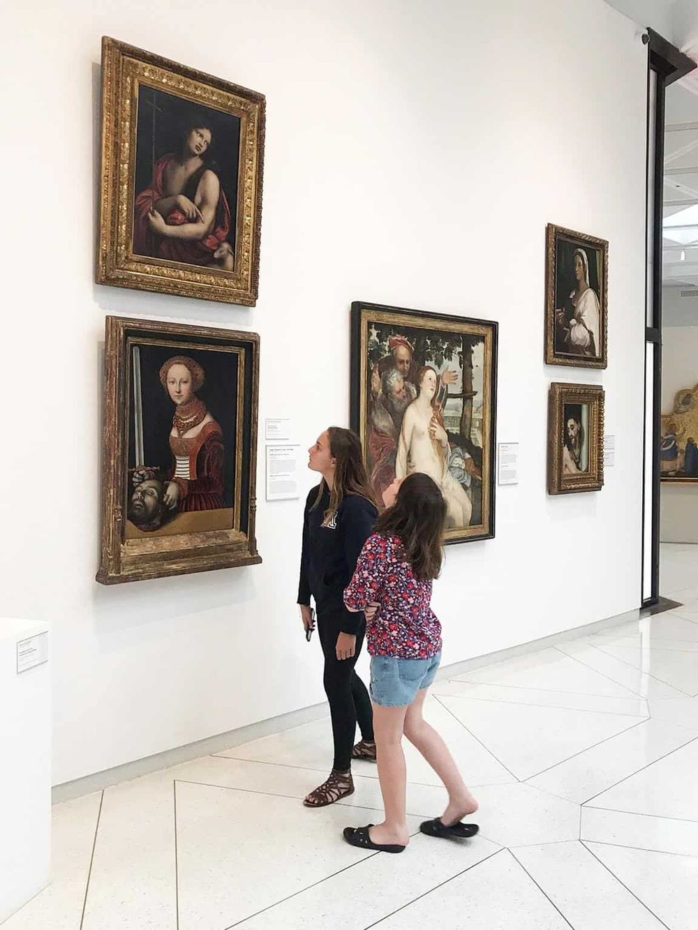 1. Art gallery with classic oil paintings, visitors exploring fine art at QuestForDirections.