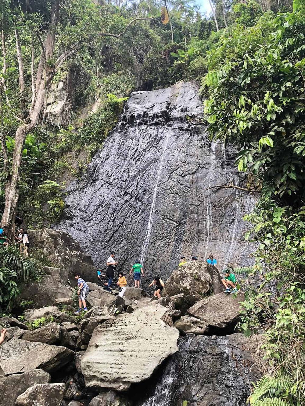 Waterfall hike adventure at QuestForDirections outdoor attraction in lush forest setting.