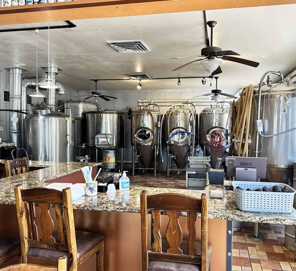 Brewing equipment and fermentation tanks in a craft brewery or brewpub setting.