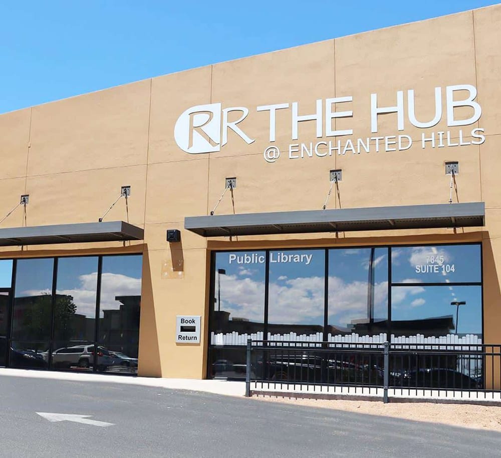 Modern public library building at Enchanted Hills with QuestForDirections signage, serving community needs.