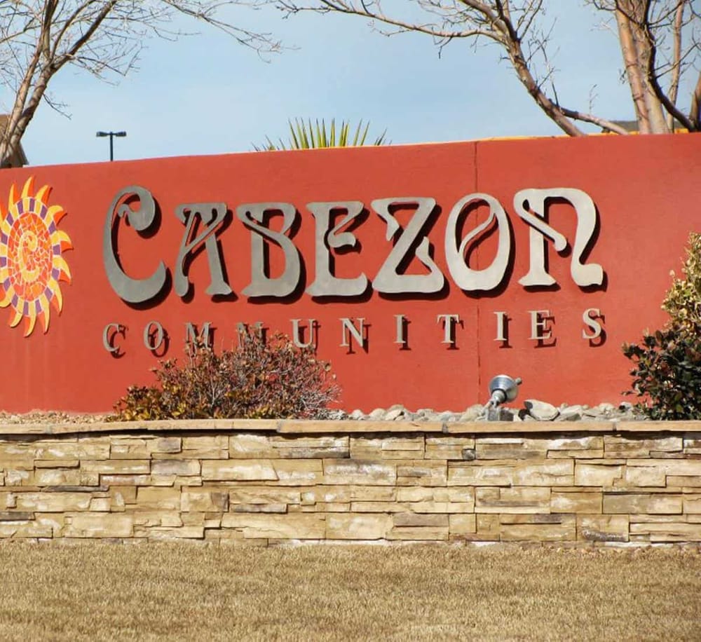Colorful Cabezón Communities sign at entrance, showcasing a popular residential area in Cabezón.