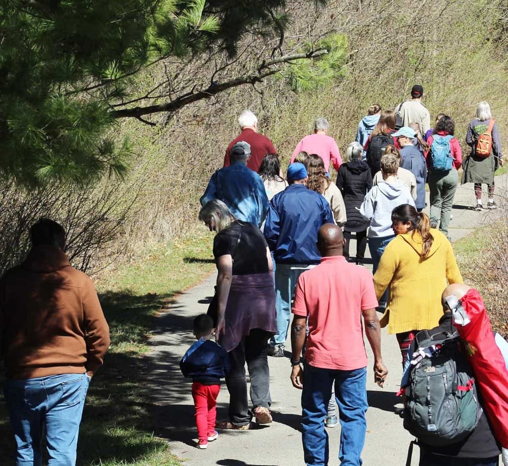Hiking trail with diverse group of people enjoying nature and outdoor adventure.