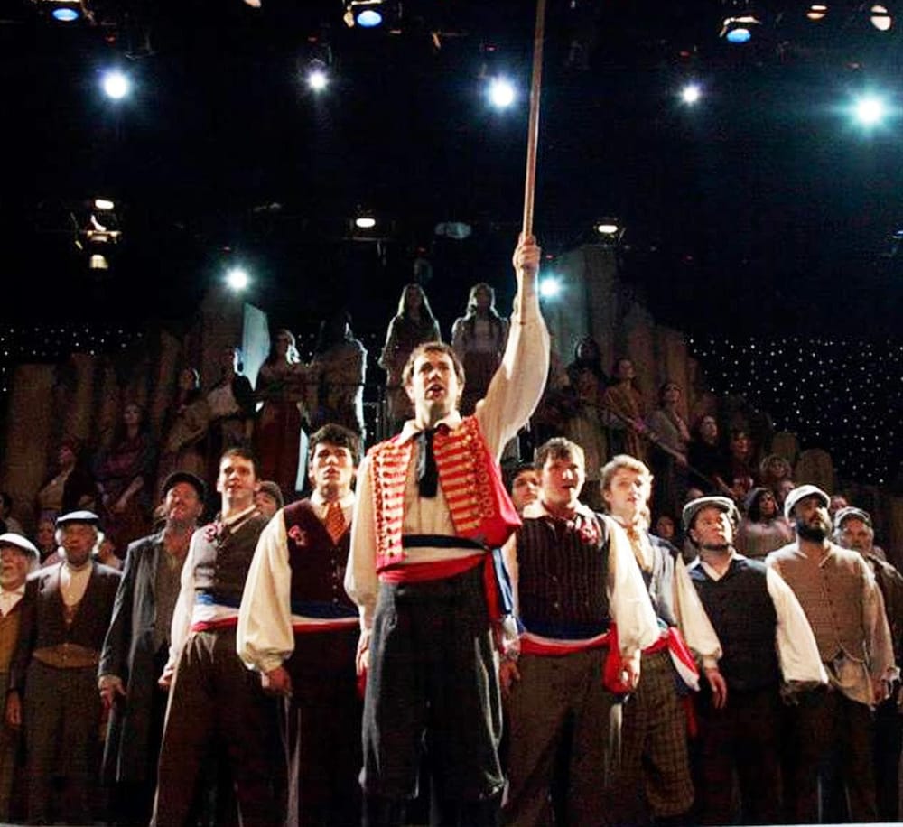 1. Performers in a theatrical production of Les Misérables on stage.