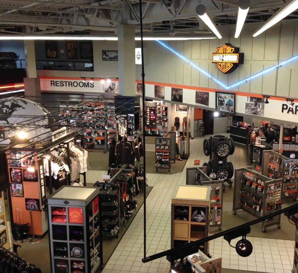 Harley-Davidson merchandise store inside a motorcycle shop, featuring apparel, accessories, and memorabilia for motorcycle enthusiasts.