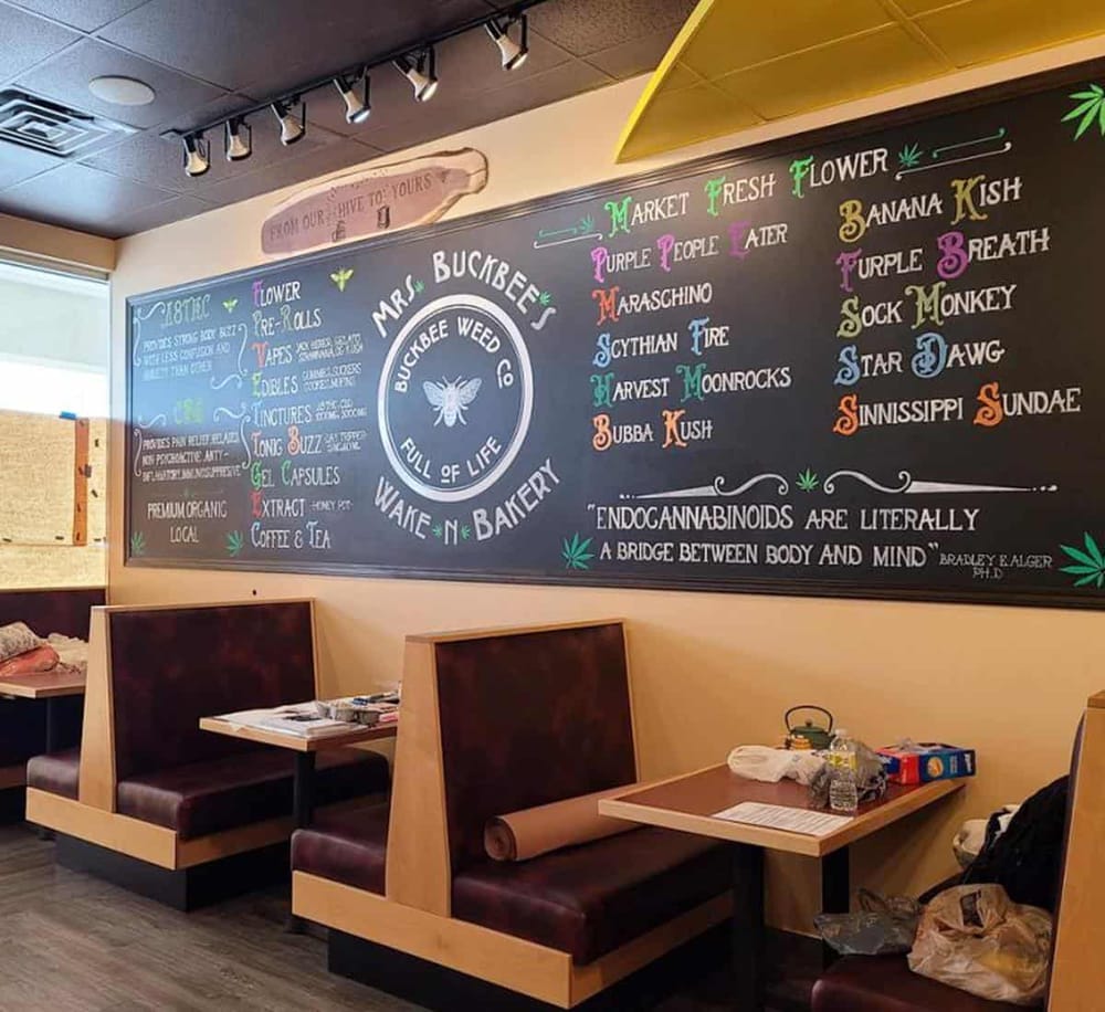 1. Chalkboard menu at Buckbee Weed Co featuring cannabis strains and educational messages.
