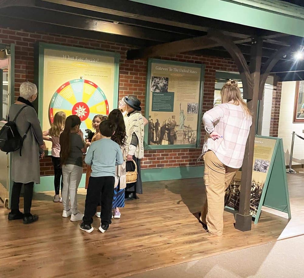 Historic Smithsonian Museum exhibit with educational displays and group of visitors exploring American history.