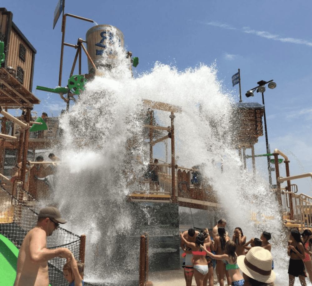 Refreshing water splash at a water park attraction on a sunny day, ideal for family summer fun and outdoor water rides.