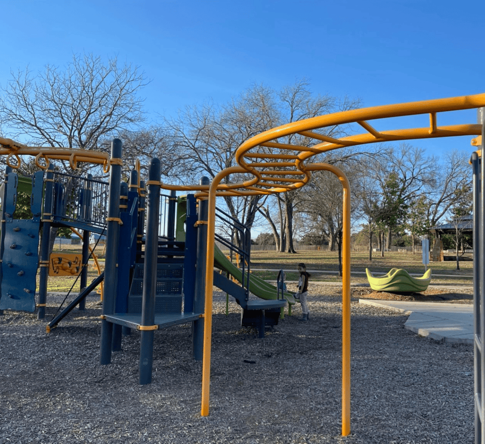 Colorful playground equipment for kids at an outdoor park during daytime.