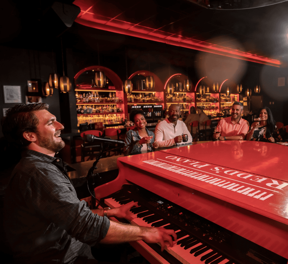 Elegant jazz performance at a cozy bar with live music, drinks, and enthusiastic audience on a night out.