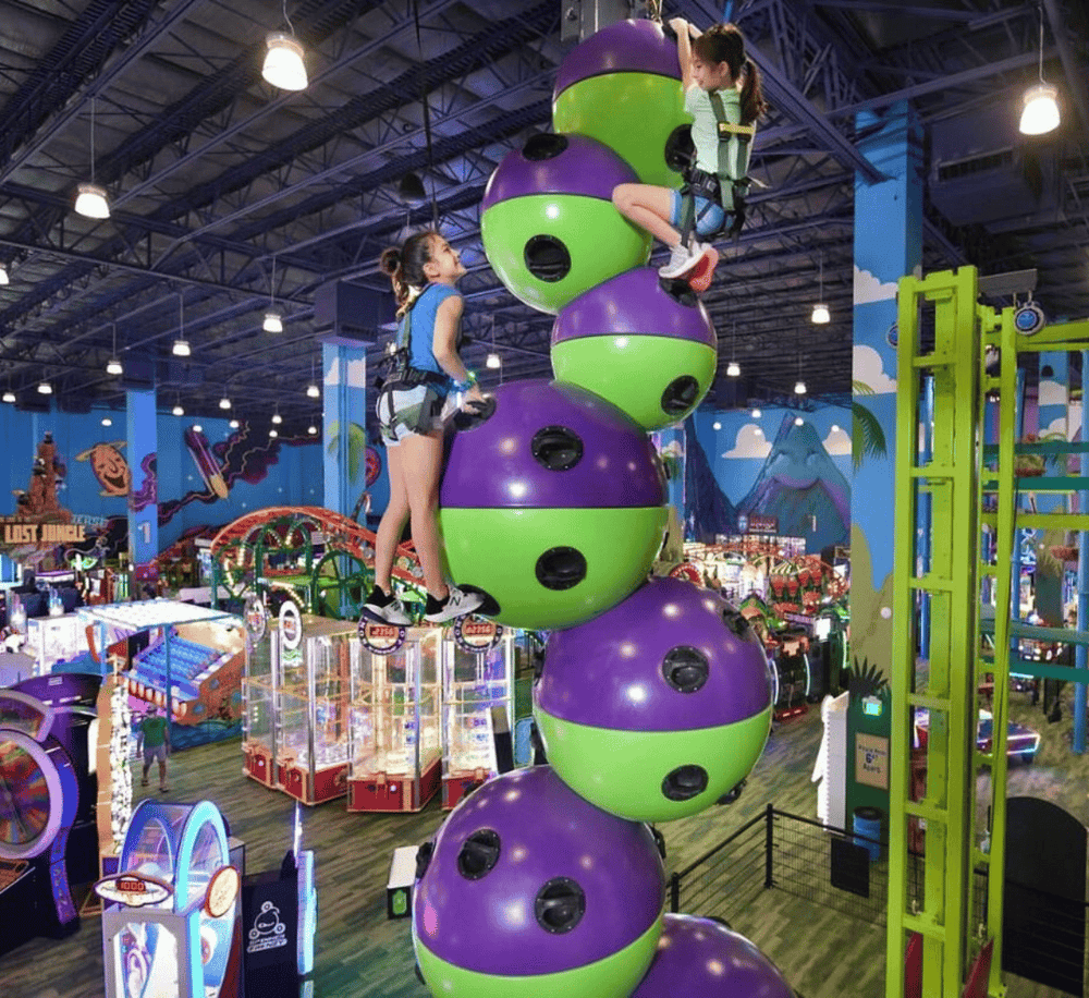 1. Indoor amusement park with kids climbing on colorful foam climbing balls.
