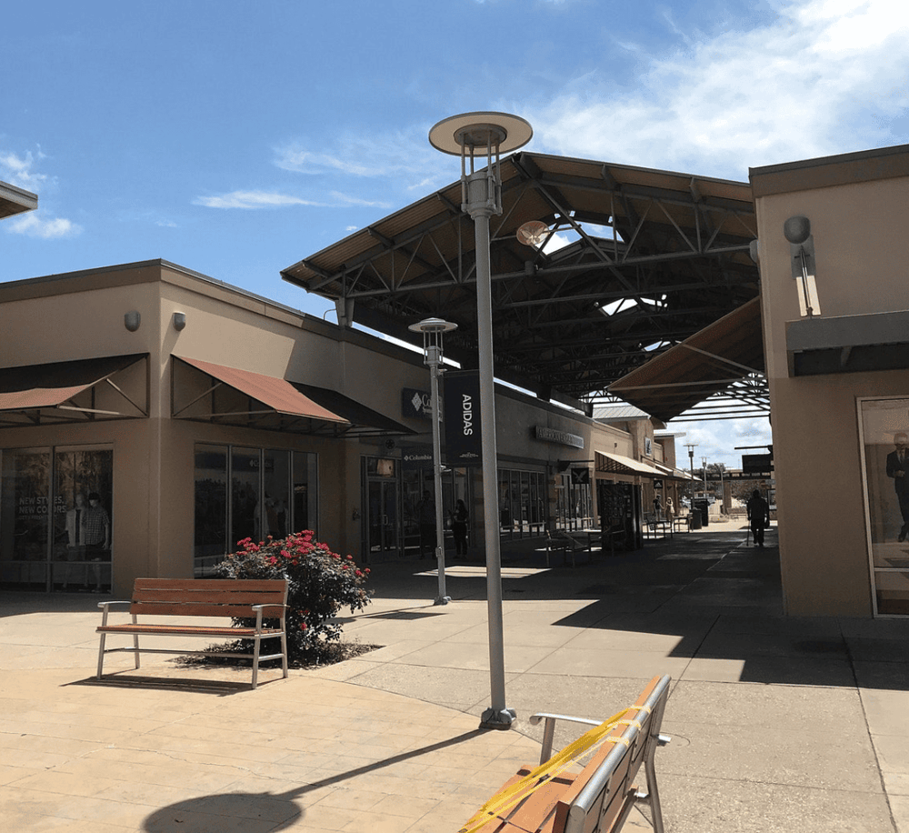 Modern shopping center outdoor mall with retail stores and seating areas, perfect for shopping and leisure.