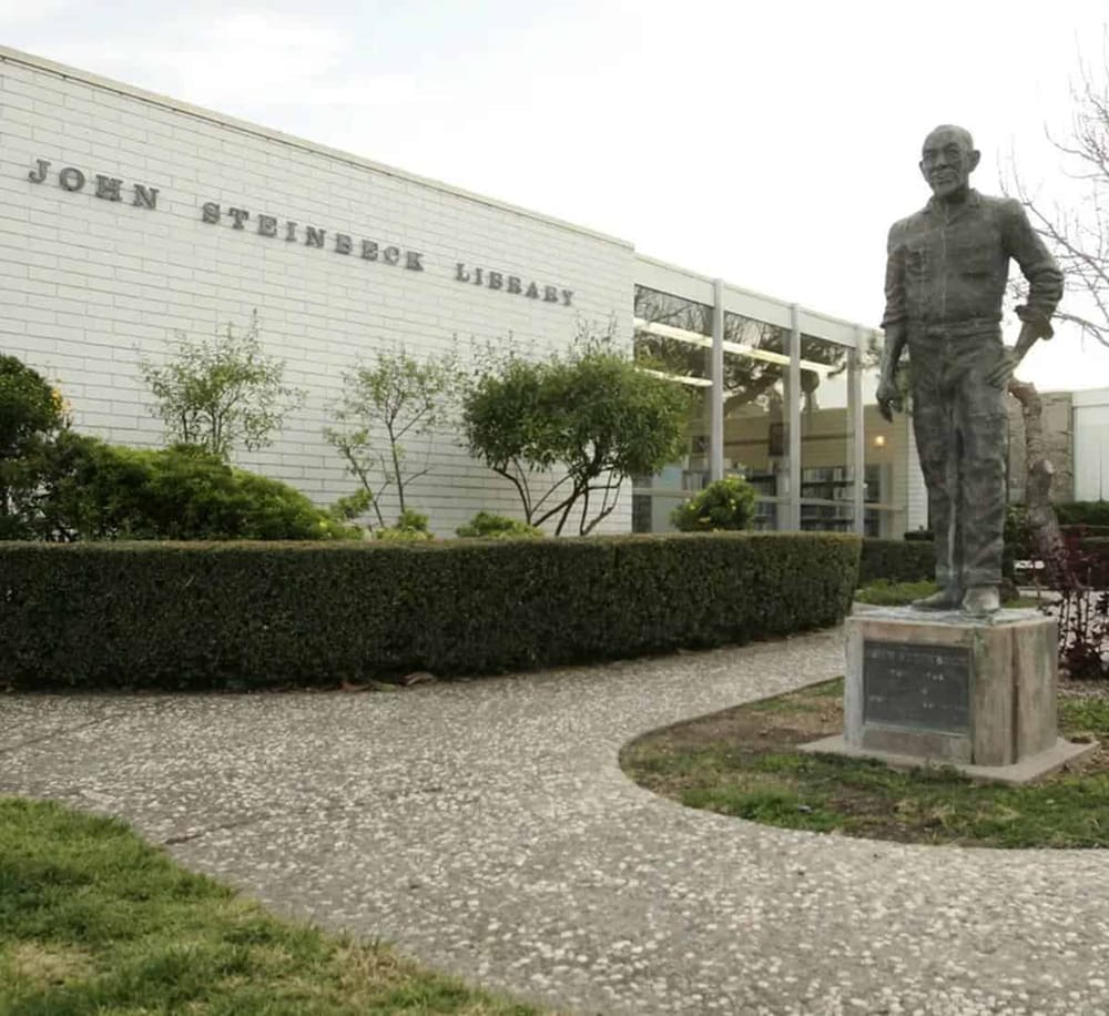 Statue of John S. Rockefeller outside John Steinbeck Library, historic community landmark.