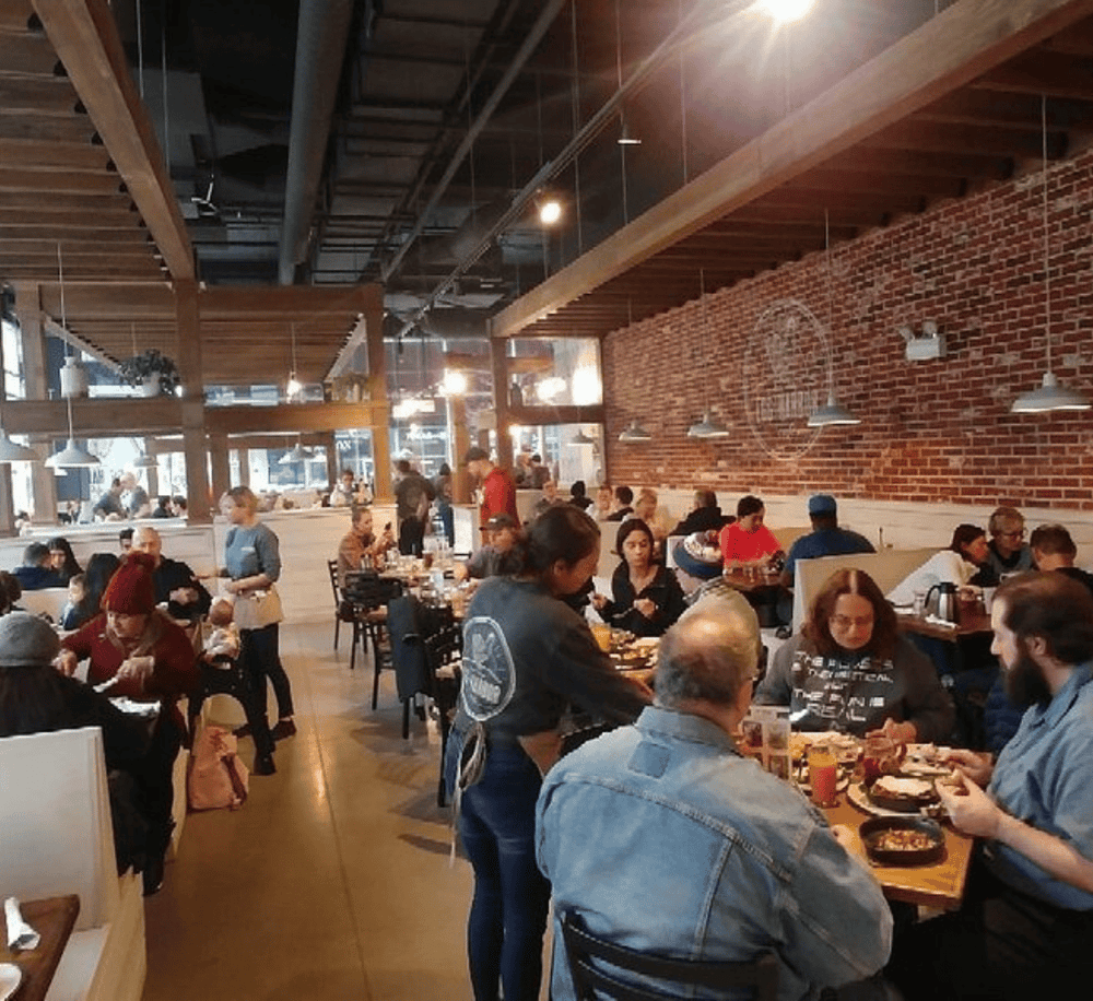 Delicious food served at a cozy, modern restaurant with brick walls and lively ambiance. Perfect for dining out and social gatherings.