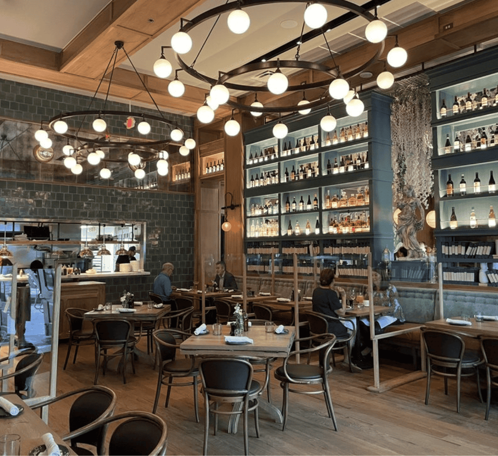 Nightlife, modern restaurant interior with stylish lighting and wine bottles décor.