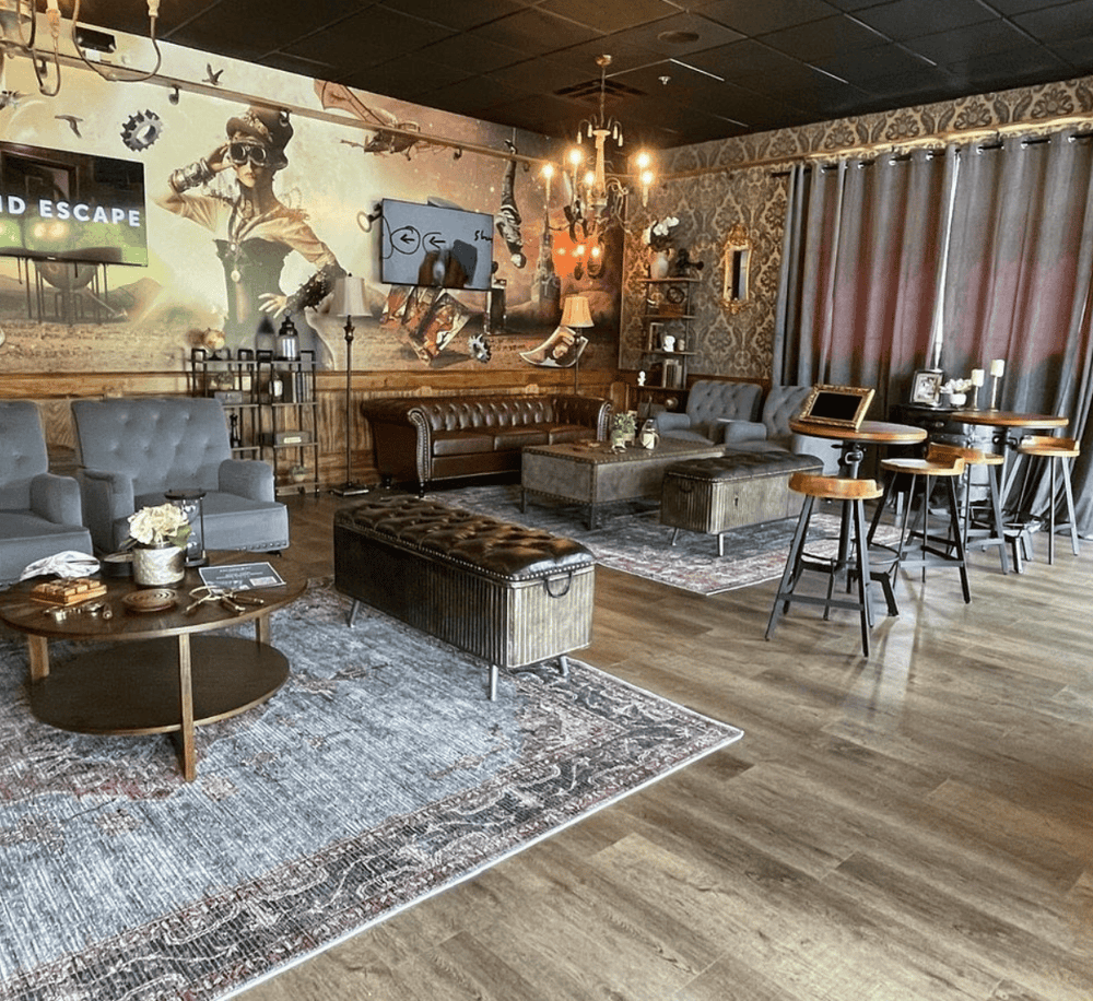 Cozy lounge interior with vintage decor, leather sofas, and a modern artistic wall mural. Ideal for relaxing or social gatherings.