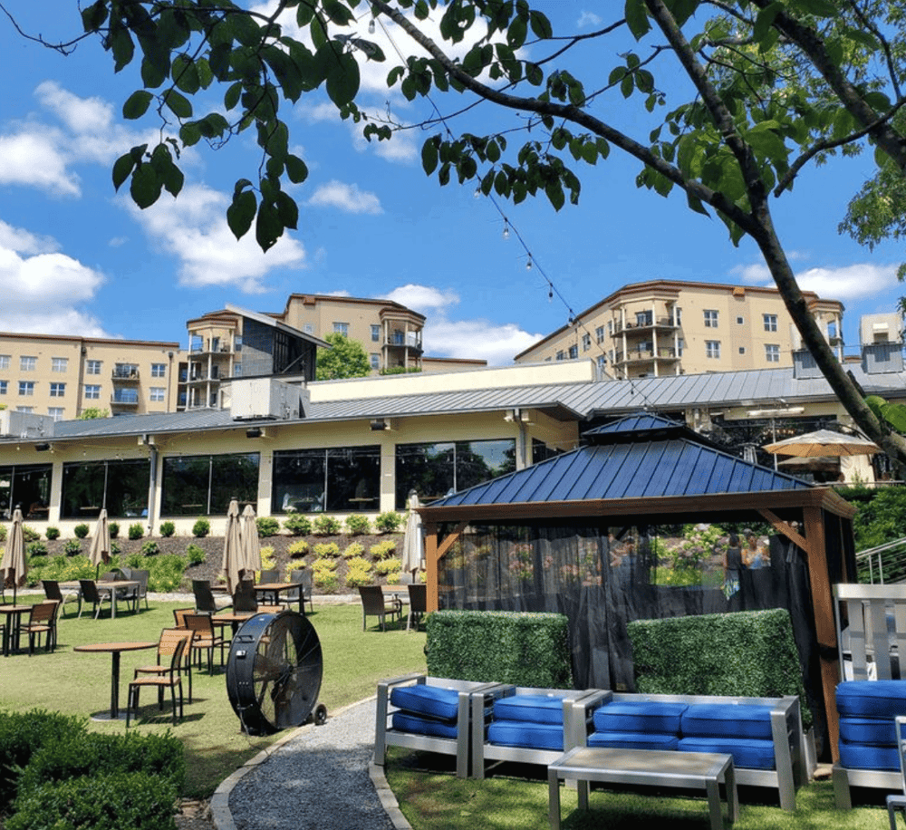 Outdoor patio with garden seating and city views at Quest for Directions.