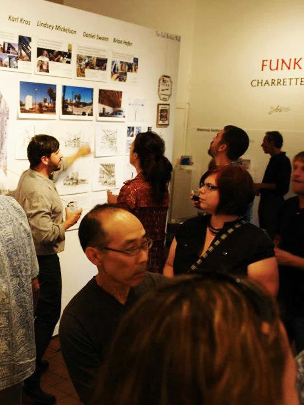 People discussing urban photography at QuestForDirections art exhibit.