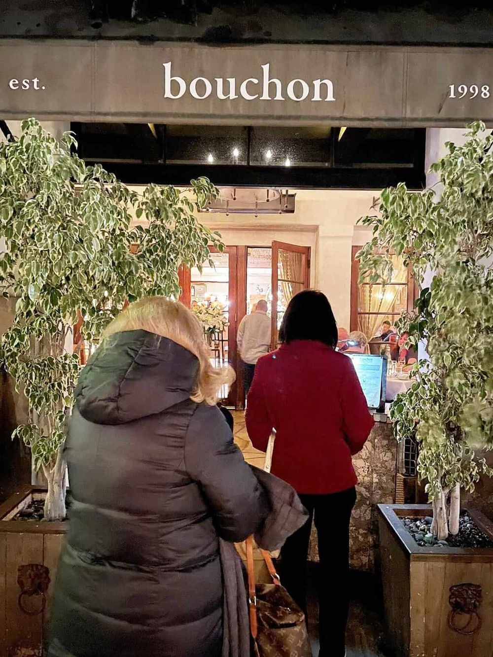 Elegant restaurant entrance, welcoming guests with natural decor and warm lighting. Perfect for a memorable dining experience.