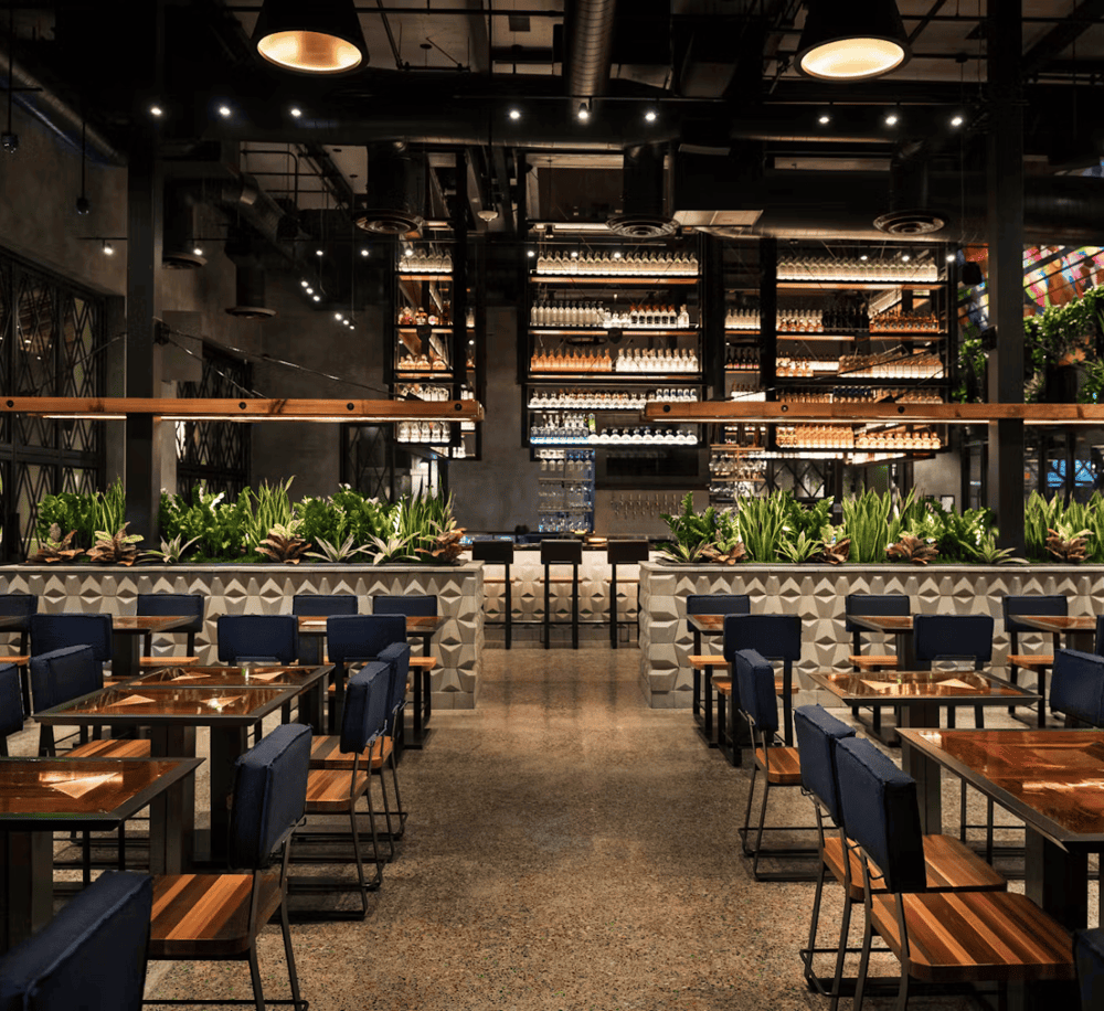 Modern industrial restaurant interior with stylish decor and ambient lighting.