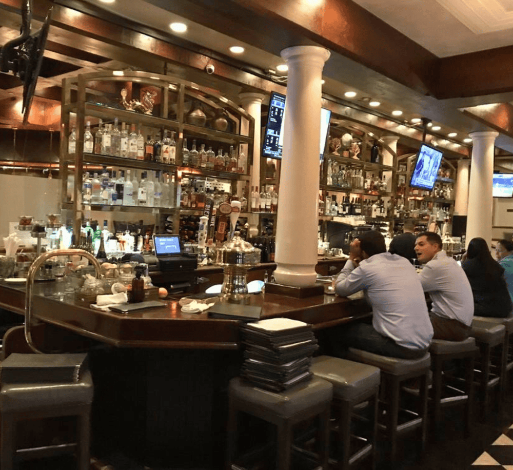 High-end bar with a variety of spirits and a cozy, social atmosphere for drinks and conversations.