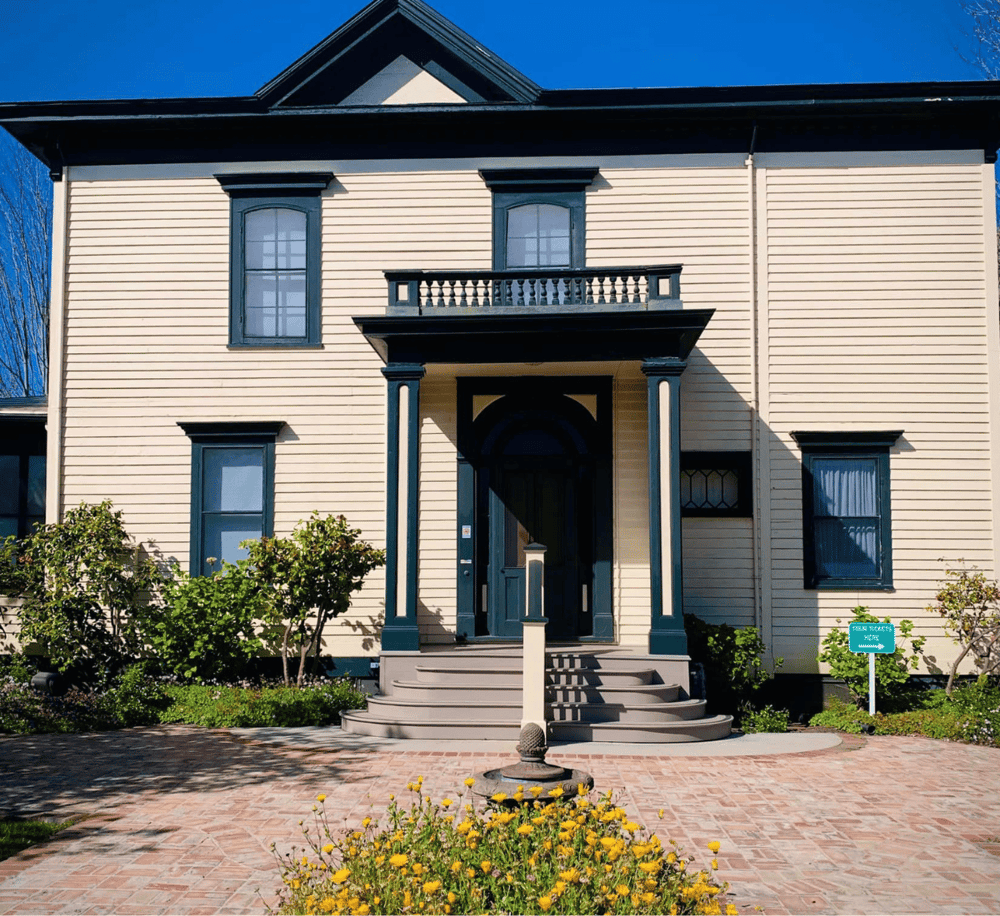 Historic Victorian-style house with elegant architecture and landscaped front yard.