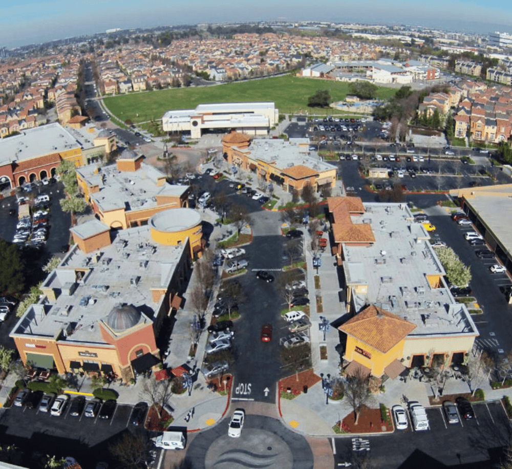Aerial view of QuestForDirections shopping center with retail stores and parking lot.