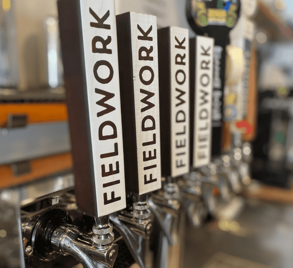 Fiddler's Green Brewery beer taps with "Fiddler WODR" labels, close-up.