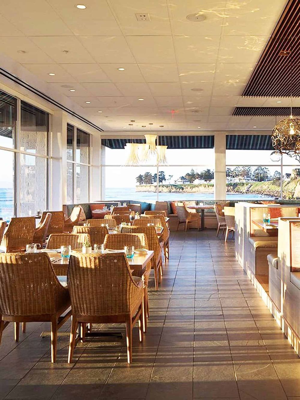 Elegant beachfront restaurant with ocean views and modern decor.