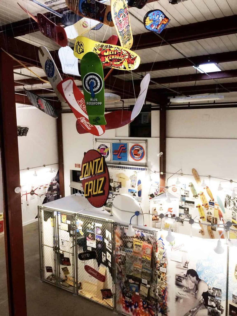 Colorful skateboard art installation at Quest for Directions skate shop, showcasing skateboards and memorabilia.