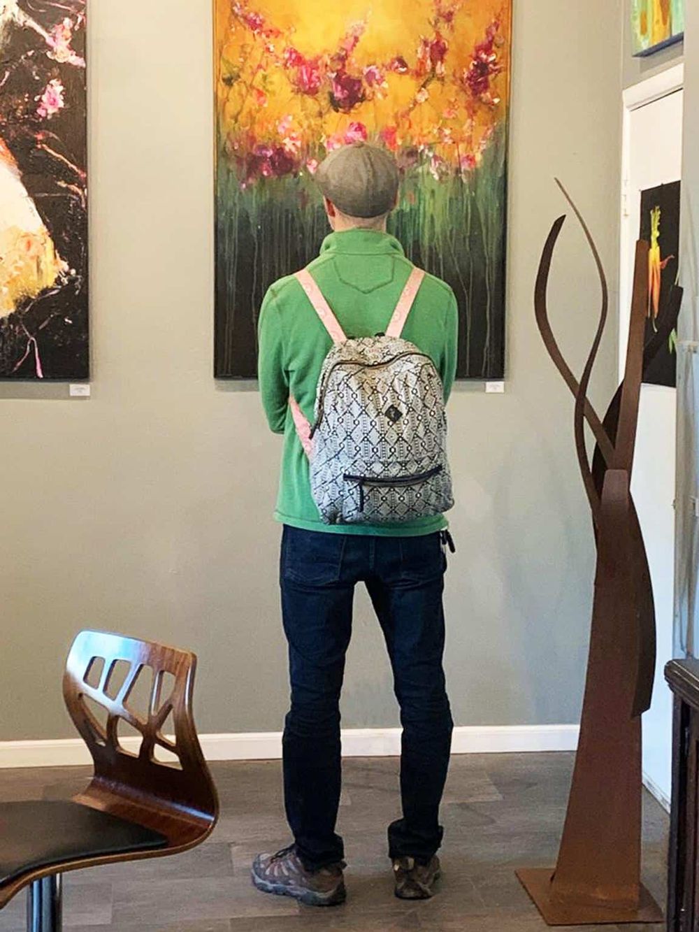 Colorful person viewing abstract art at QuestForDirections art gallery.