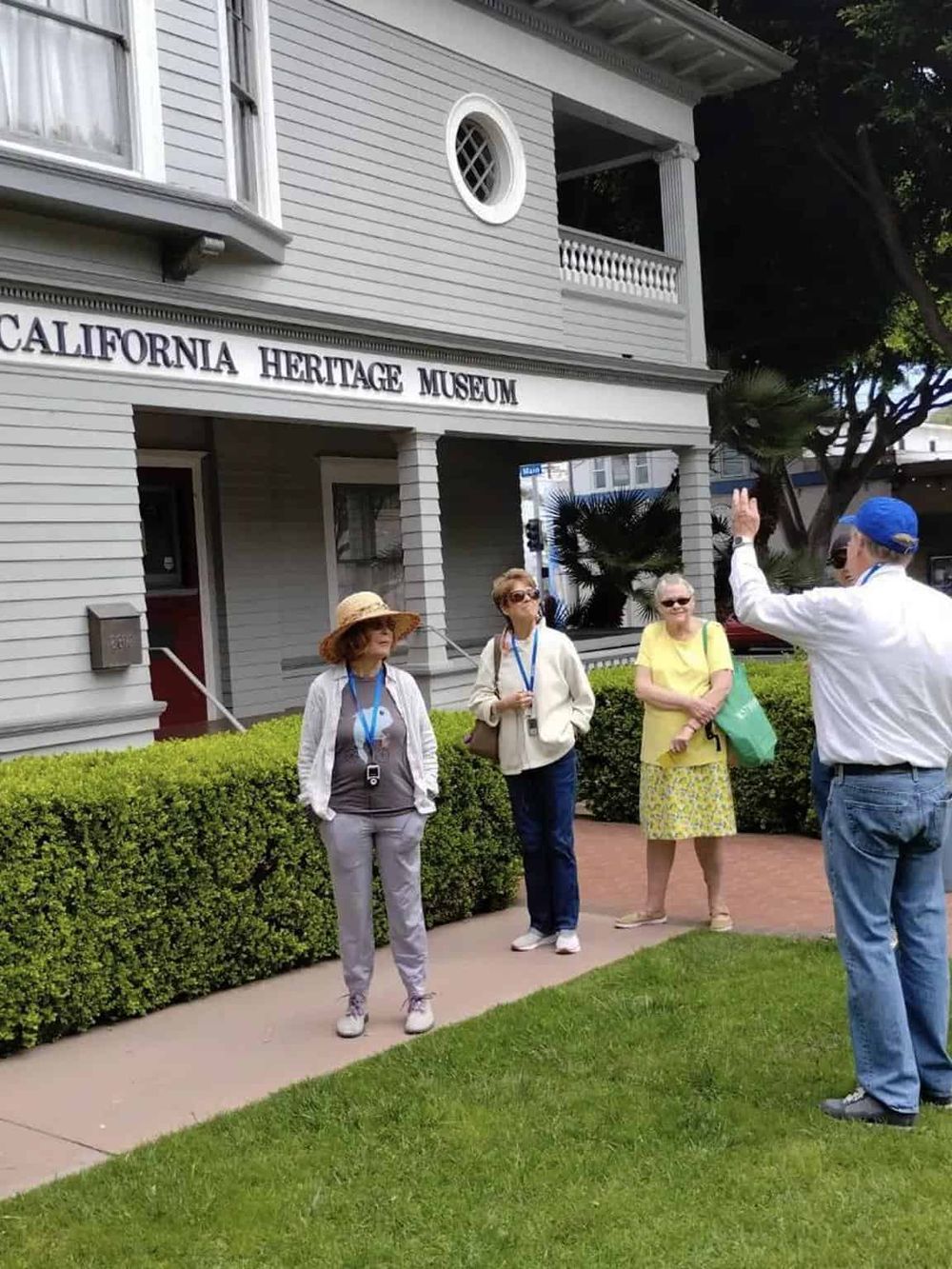 Historic California Heritage Museum guided tour with visitors listening to a guide.