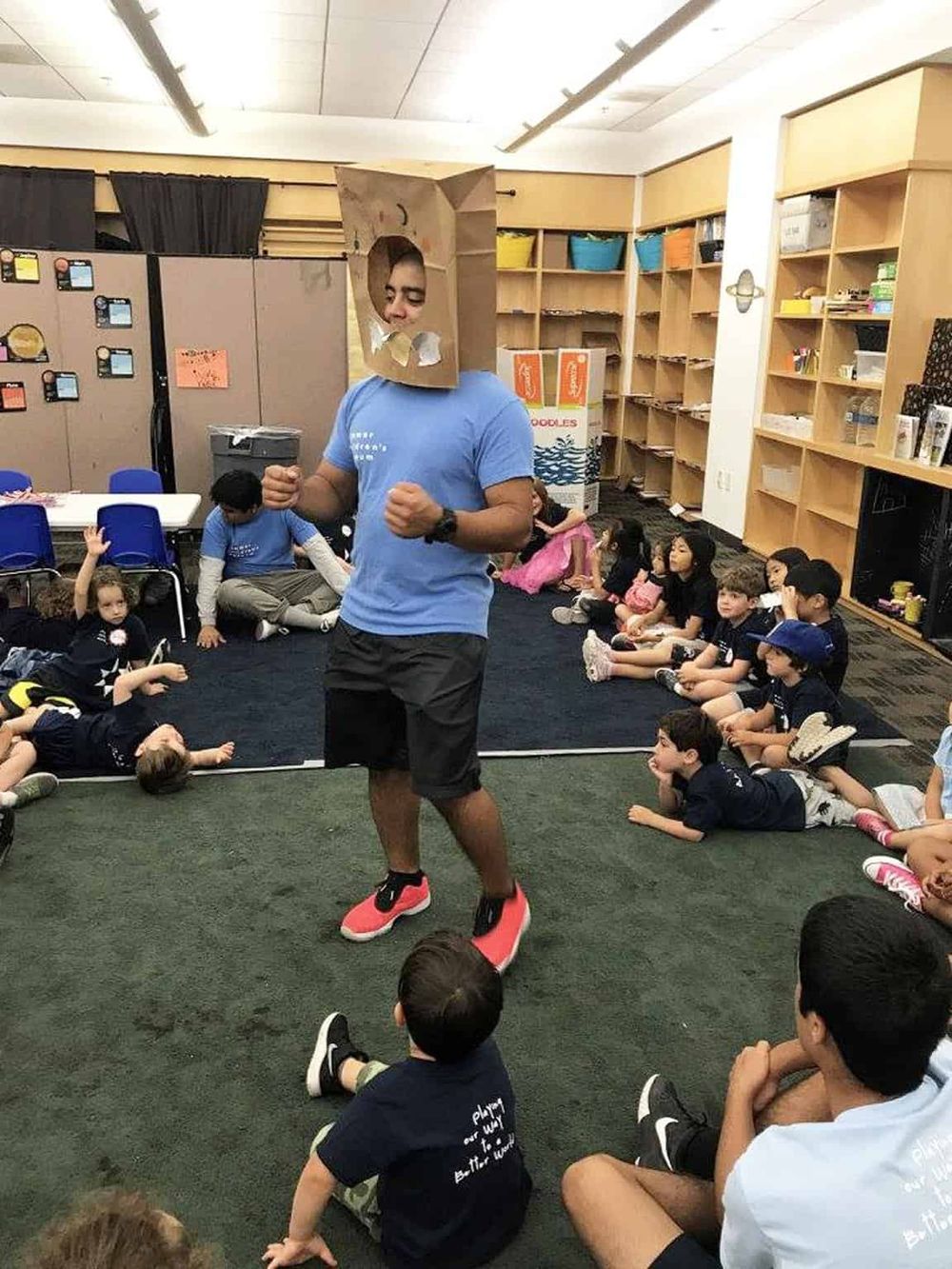 Funny classroom costume party with kids and teacher, engaging activity, creative dress-up, educational entertainment, group celebration.