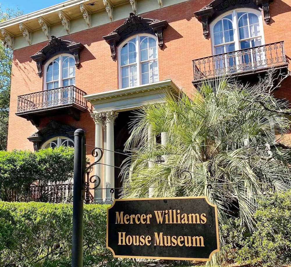 Elegant historic house museum with Victorian architecture and lush greenery, located in the Mercer Williams neighborhood.